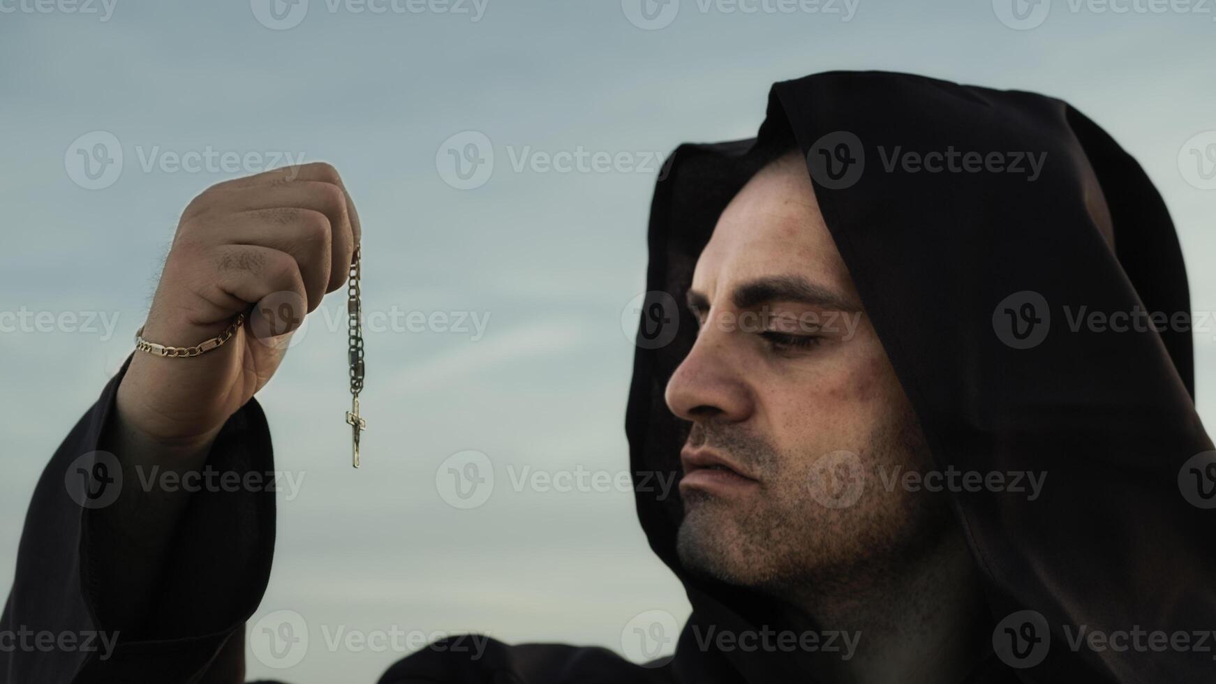 Religious Monk Kisses The Crucifix Jesus In Symbol Of Faith photo