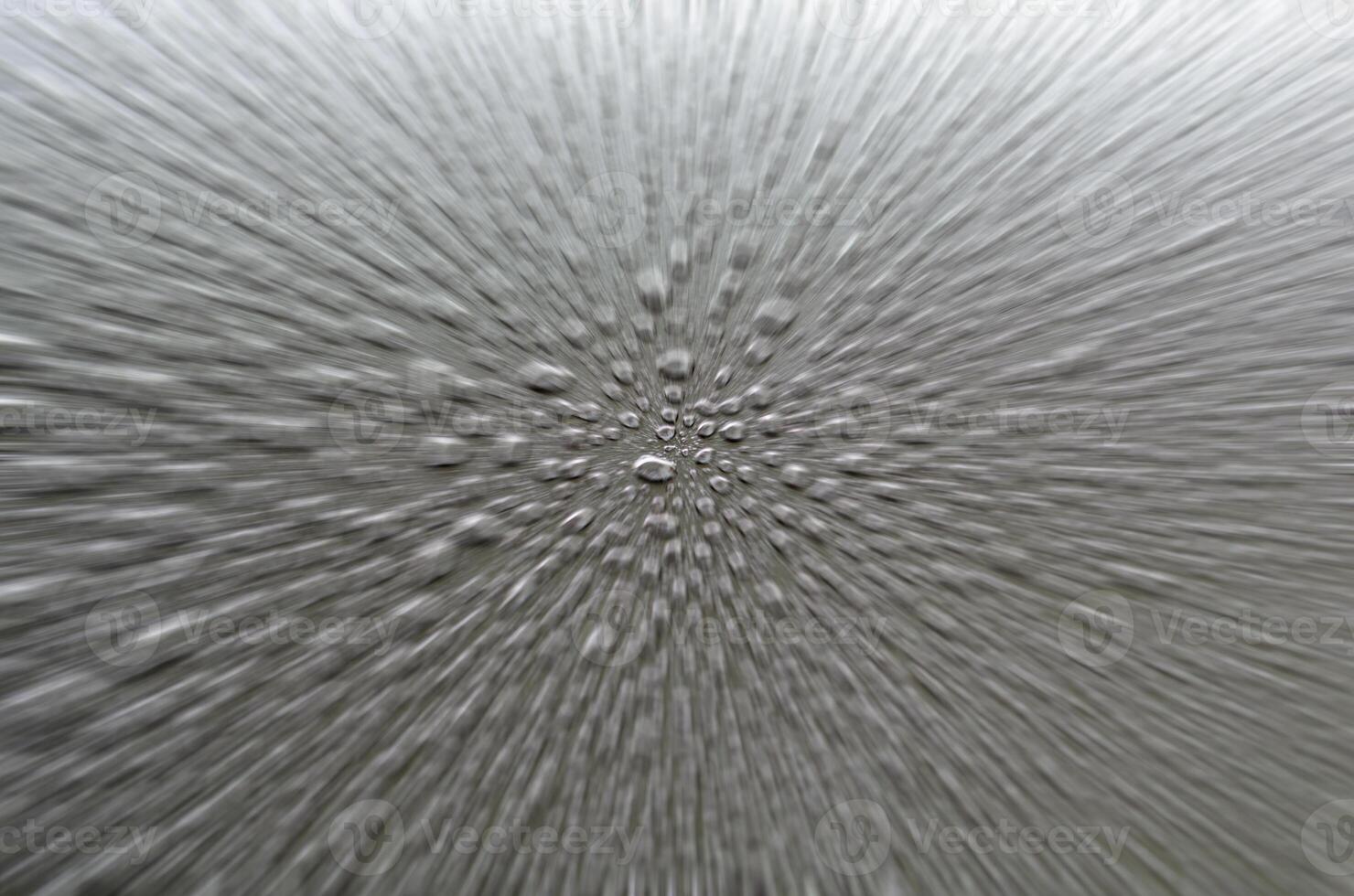 Straight view of raindrops on dark cover background with zoom in effect photo