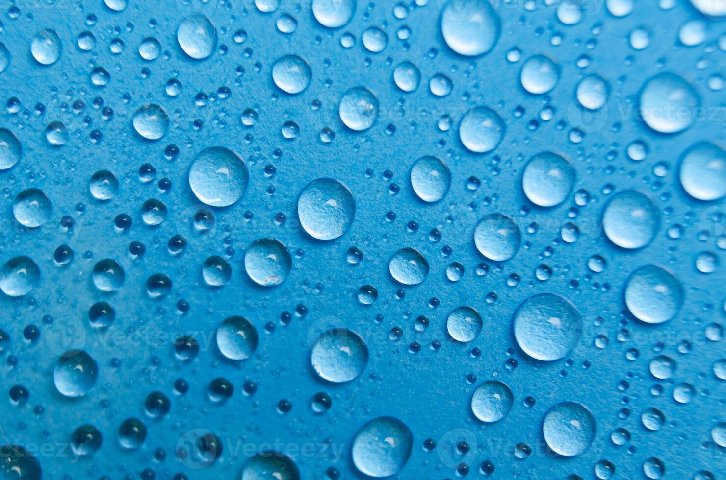 Close up of rain droplets on blue cover background. Suitable for wallpaper background photo