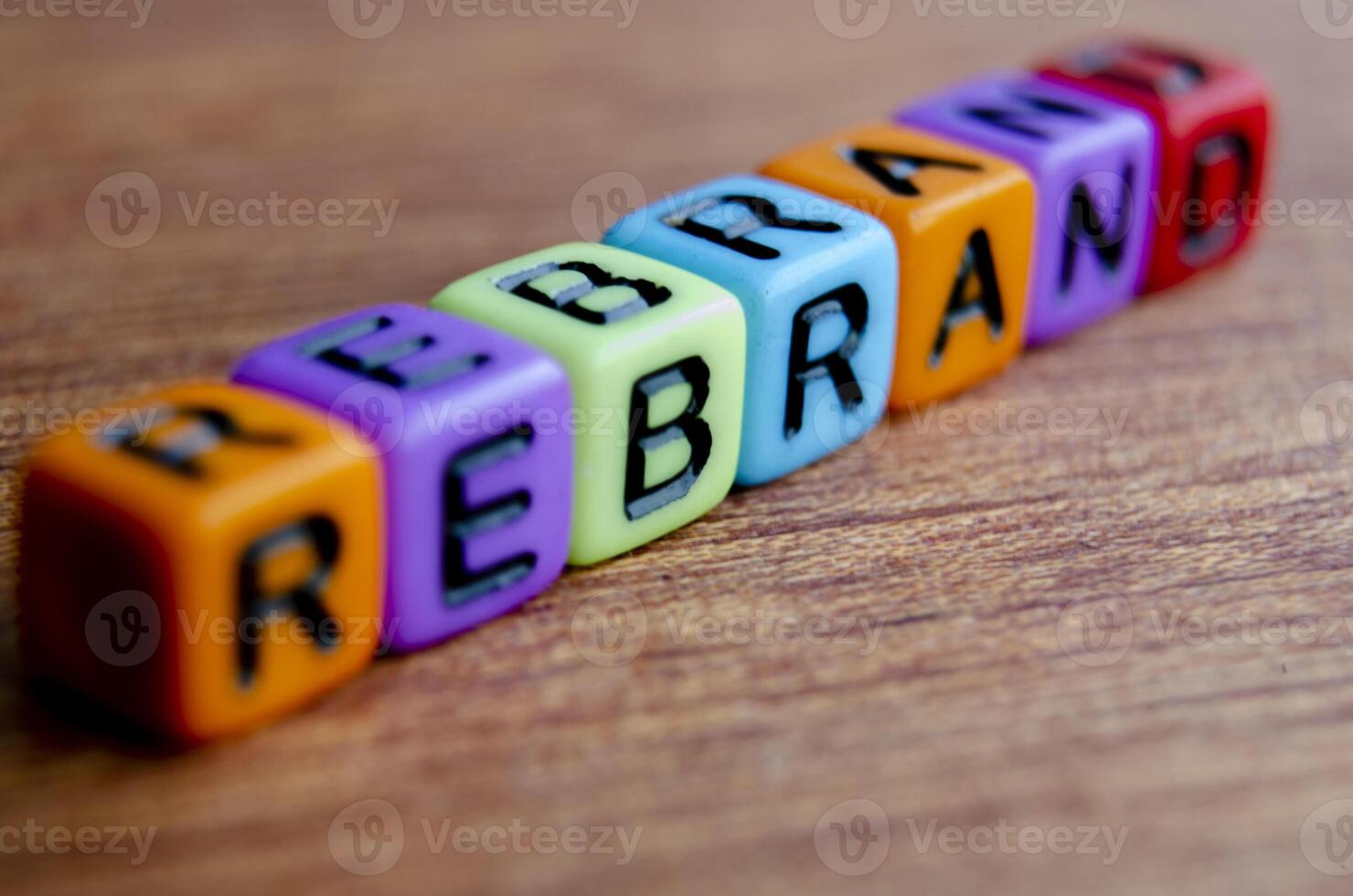 Close up view of REBRAND text on wooden table photo