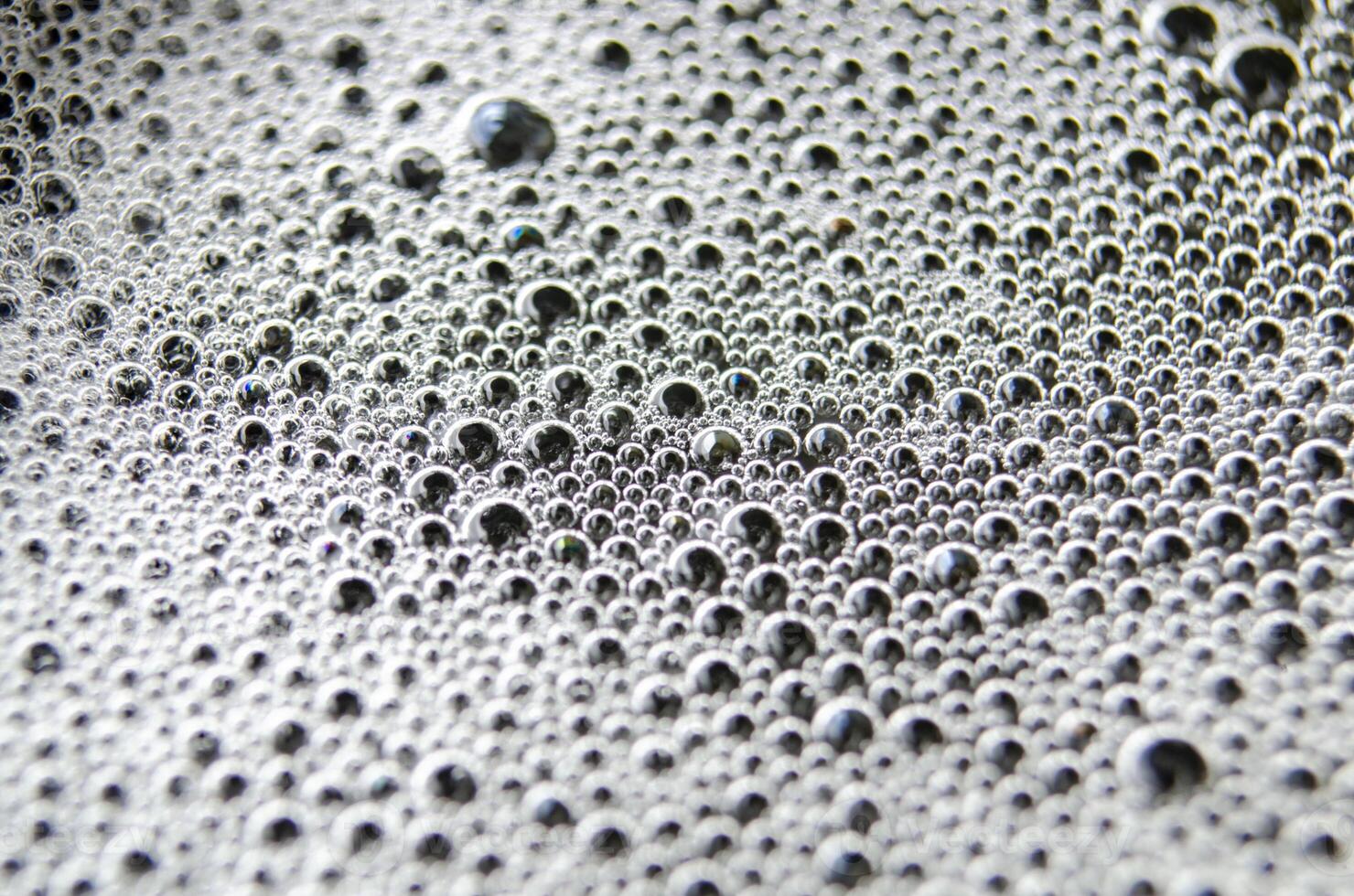 Top view of tiny bubbles on dark background. Suitable for wallpaper or design photo