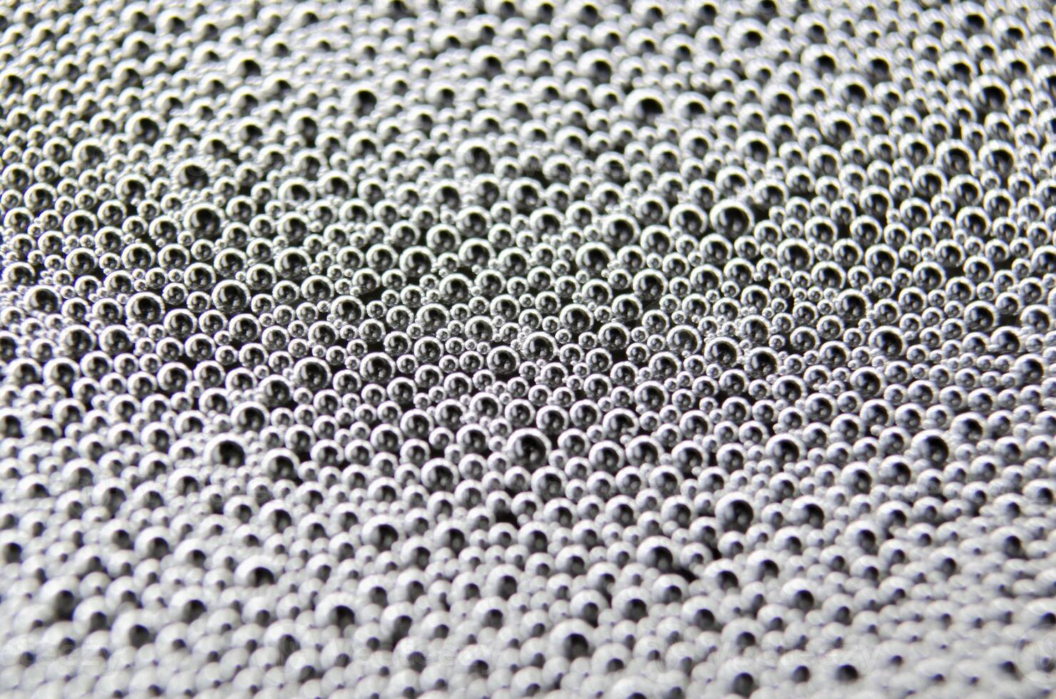 Top view of soap bubbles forming patterns on a textured surface. Suitable for wallpaper background or design photo