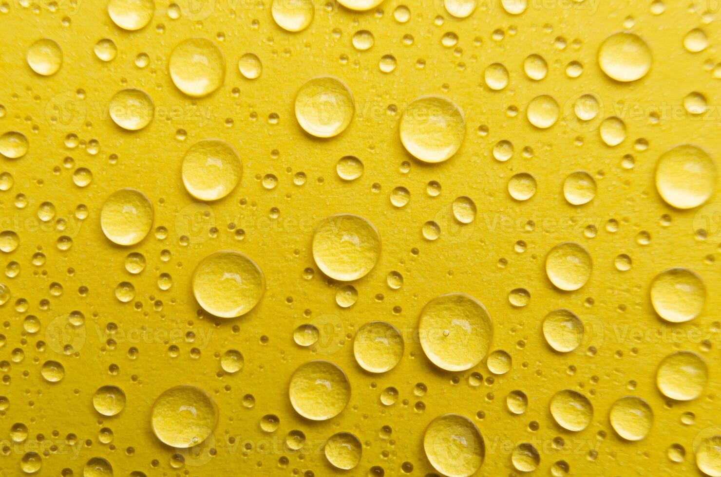 Rain droplets on yellow color background suitable for wallpaper decoration or design photo