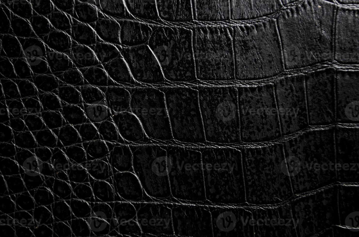 Close up of black crocodile skin artificial leather with customizable space for text or for mockup photo