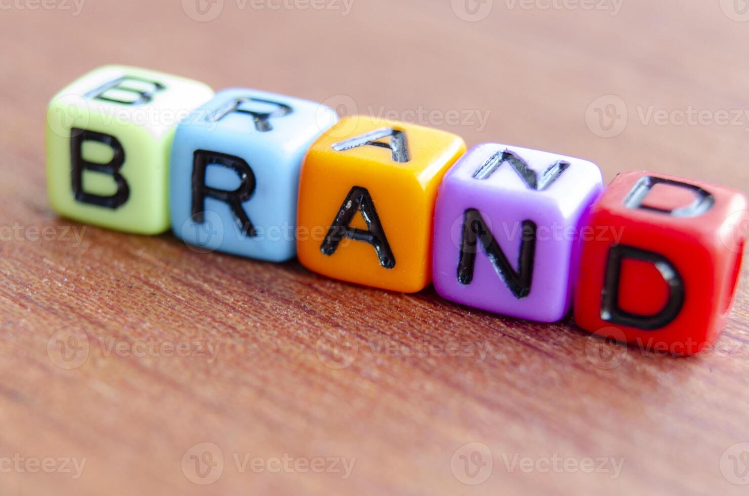 Brand text multicolor cubes on wooden table photo
