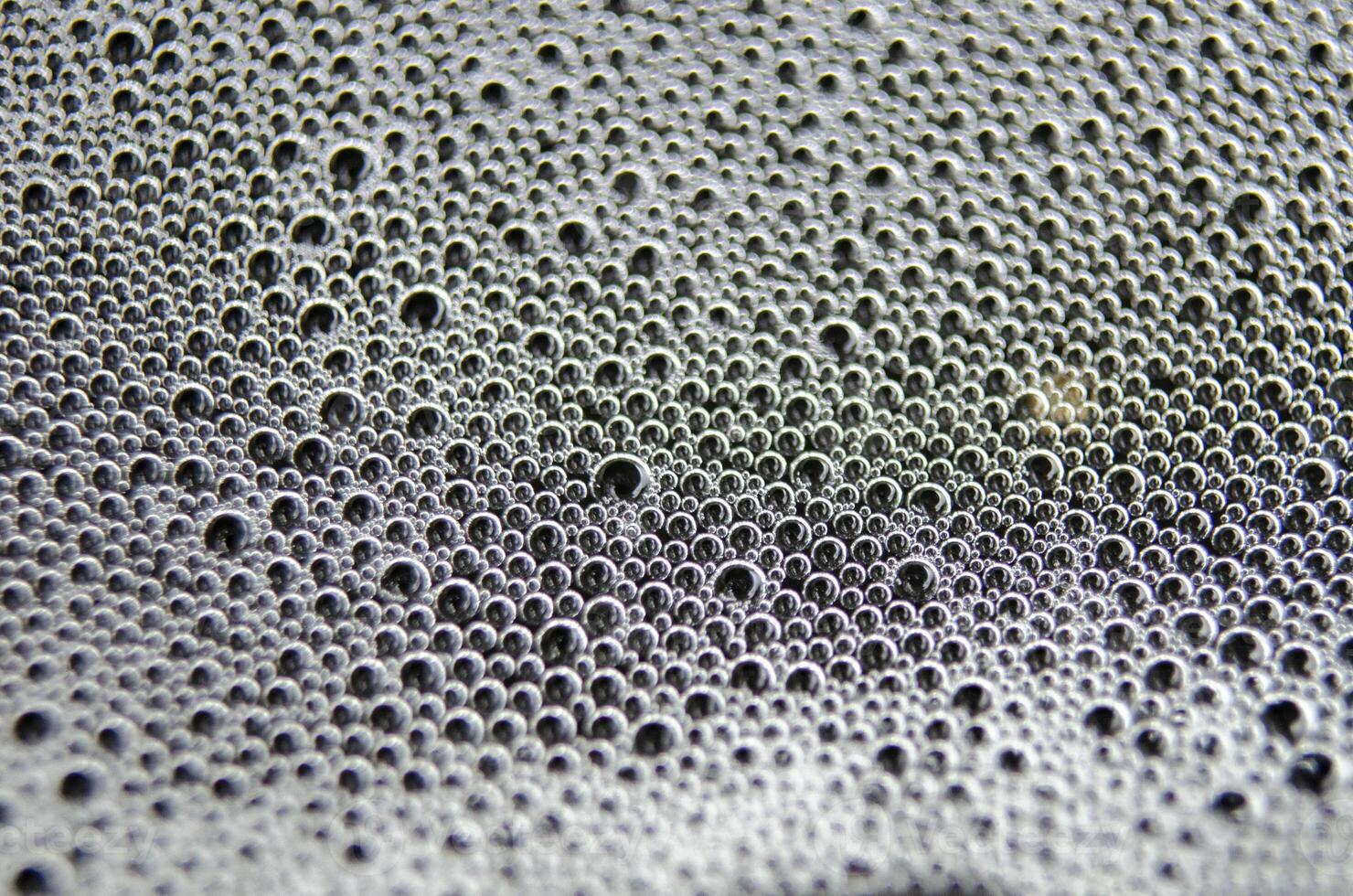 Soap bubbles forming patterns on a textured surface. Suitable for wallpaper background or design photo