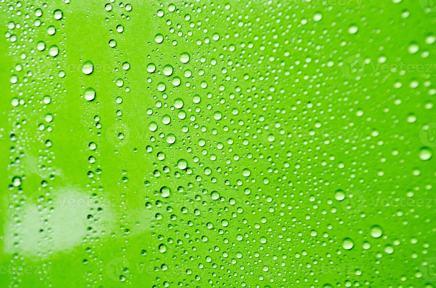 Rain water droplets on green cover background. Water droplets concept photo