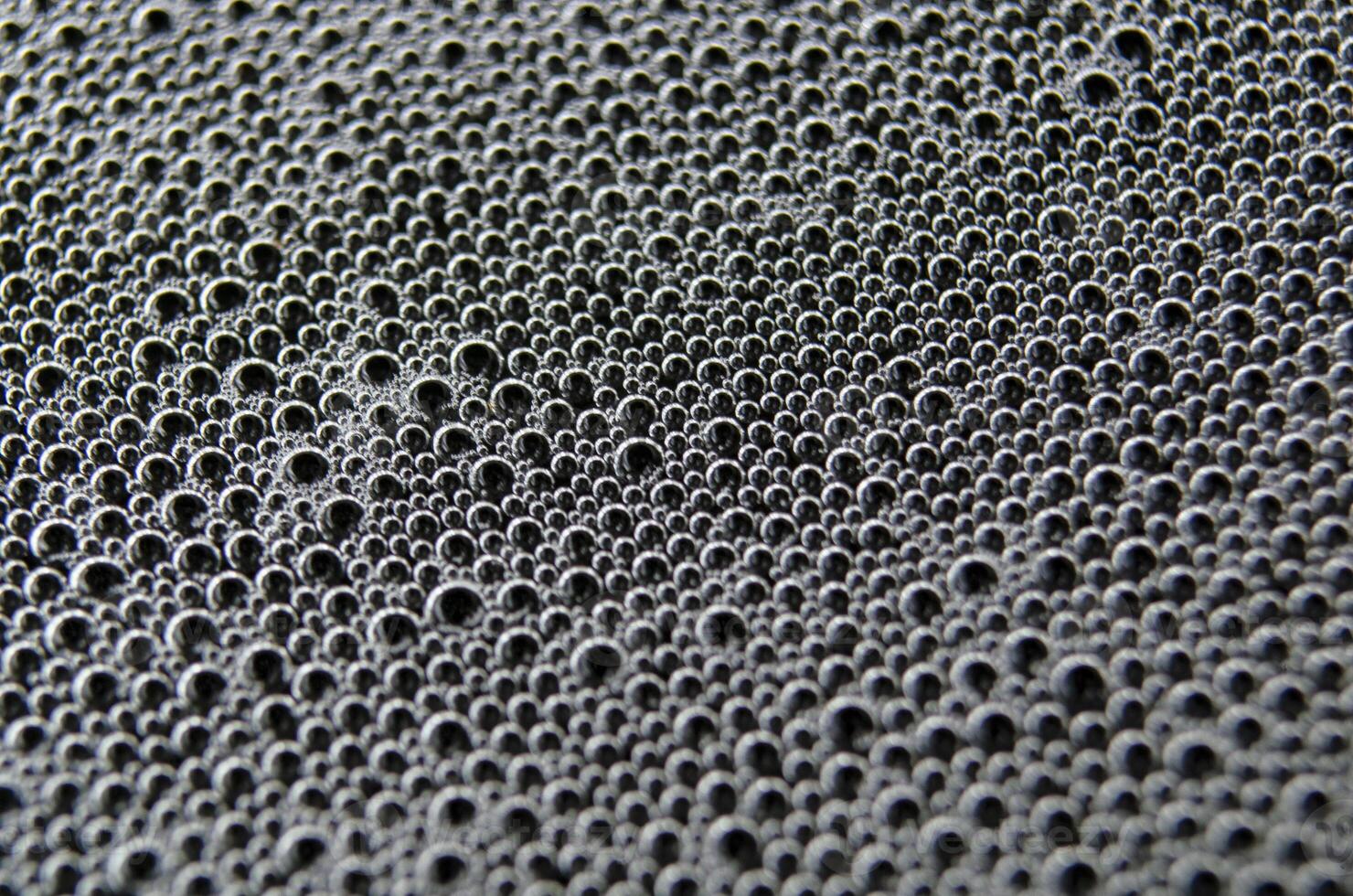 Top view of air bubbles trapped inside a gel-like transparent substance. photo
