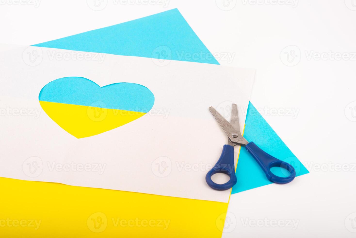 heart cut out of paper and painted in blue and yellow colors as symble of Ukraine. Creativity as support of Ukraine photo