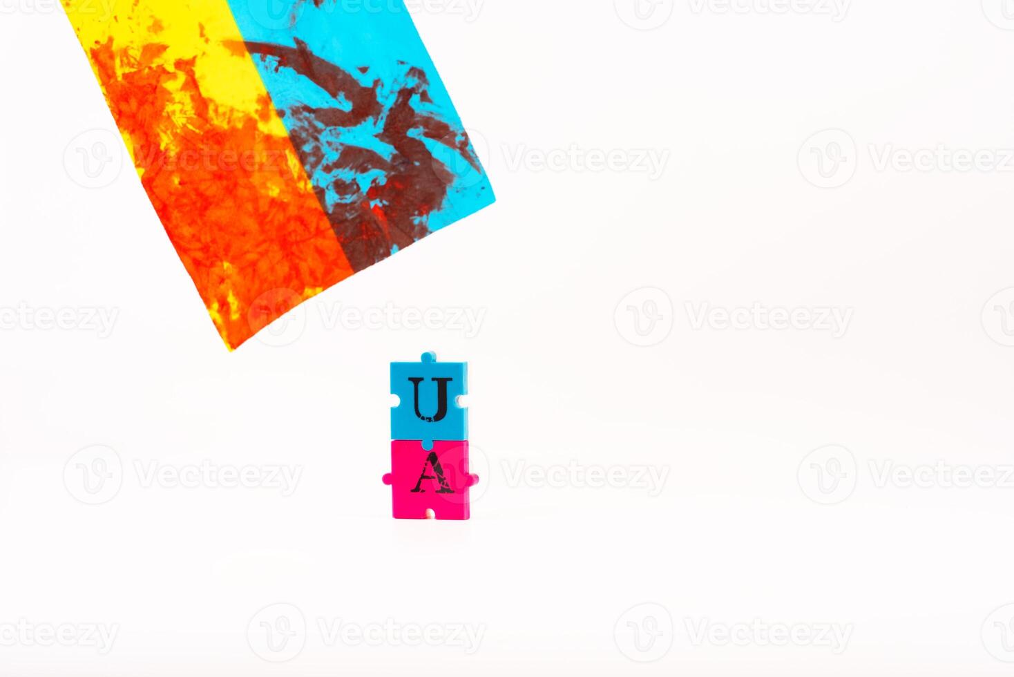 Flag of Ukraine with blood and puzzles with letters of Ukraine on a white back. As the symble of struggle photo