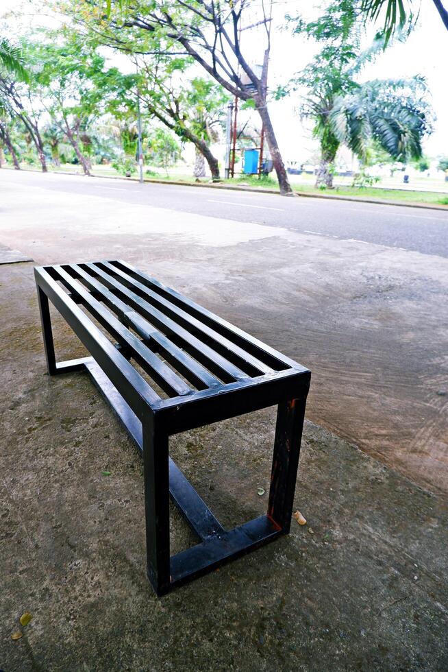black bench made of iron. a bench with gaps in the seat photo