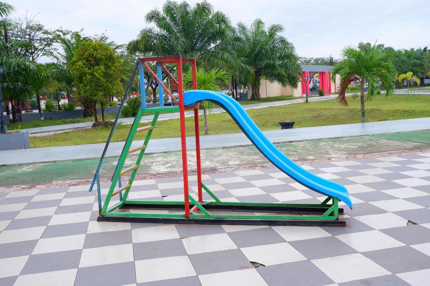 blue slide with iron stairs for children to play in the park photo