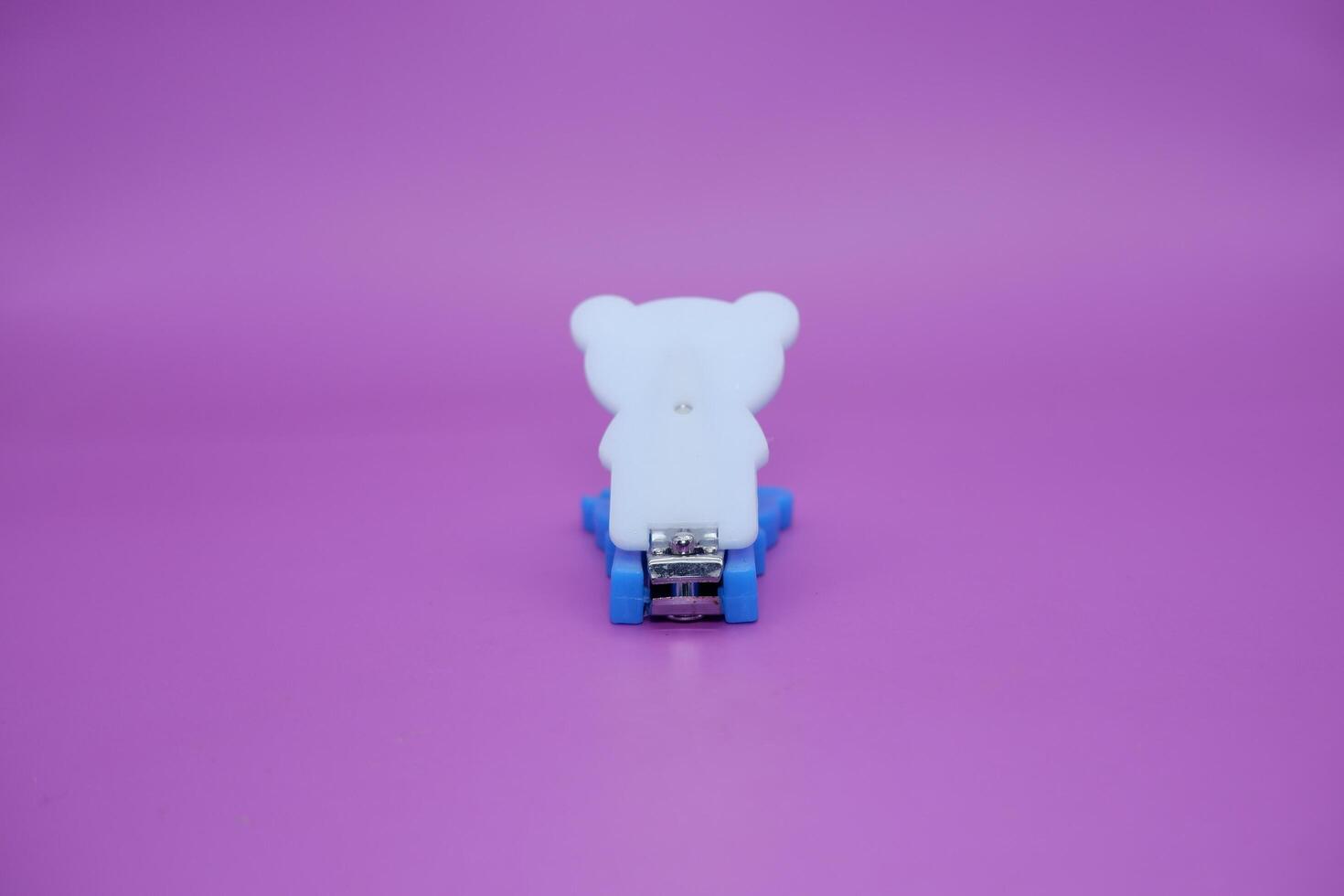 cute nail clippers isolated on purple background. cute nail clippers with blue and white color combination photo