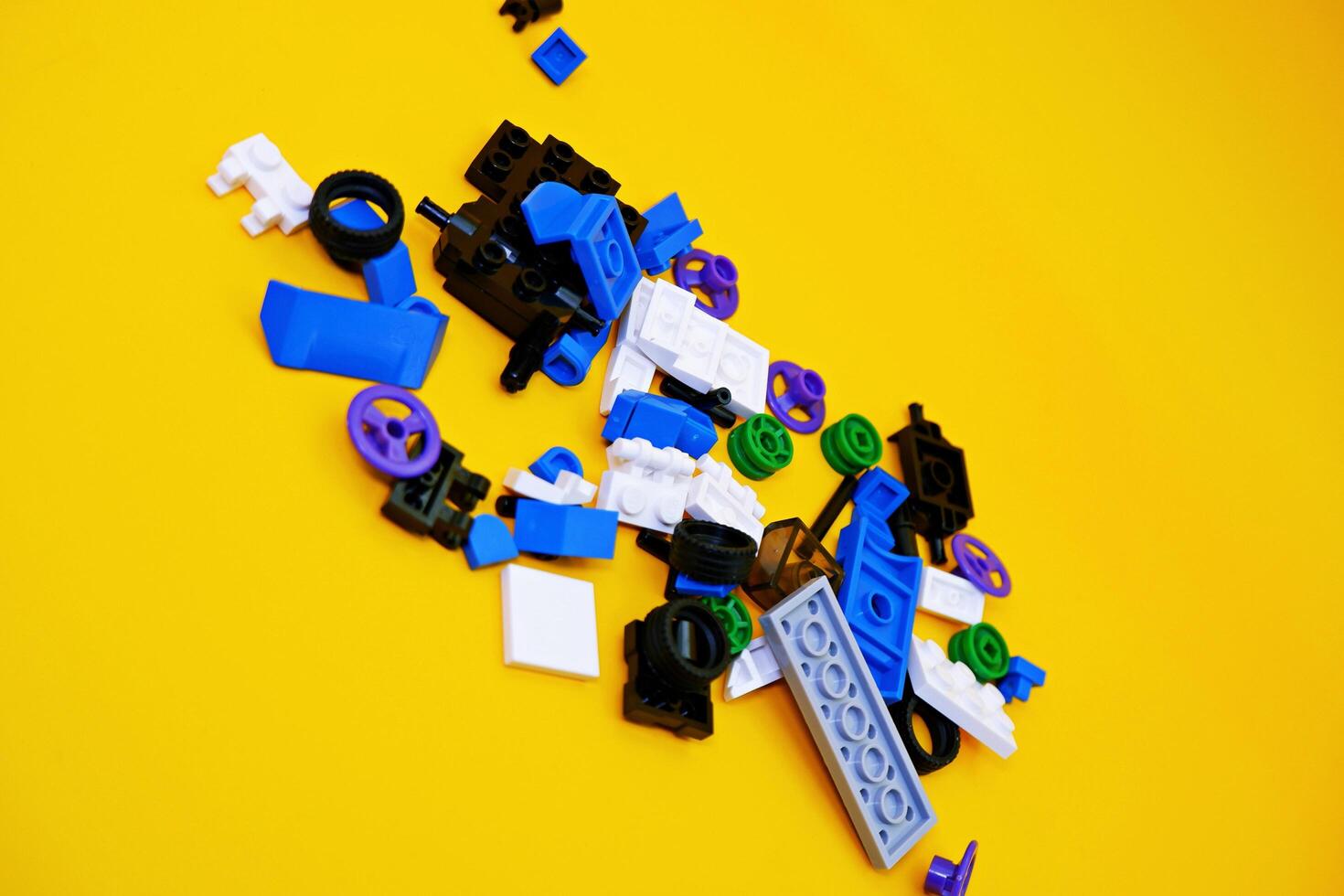A collection of toy blocks isolated on a yellow background. Toys that are played by stacking them like stacking bricks. photo