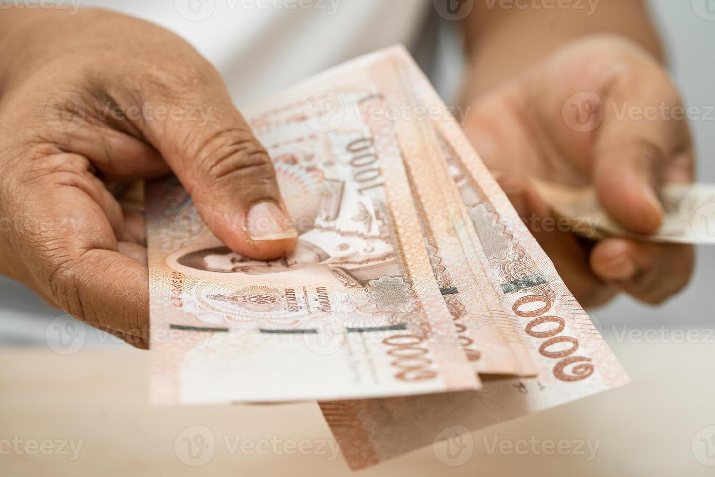 Asian woman holding Thai banknotes money, economy finance exchange trade investment. photo