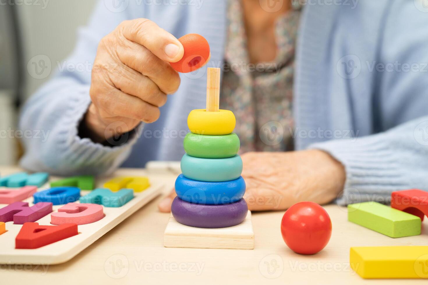 Alzheimer disease AD, Asian elderly woman patient suffering from dementia learn practical motor skills rehabilitation. photo