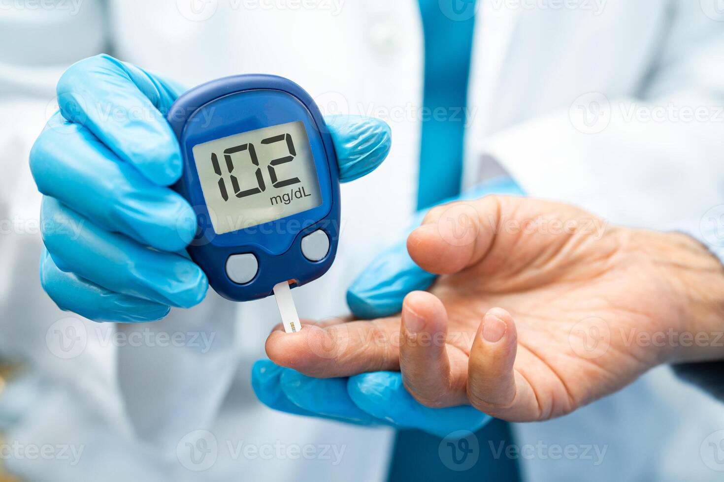 Doctor check diabetes from finger blood sugar level with finger lancet. photo