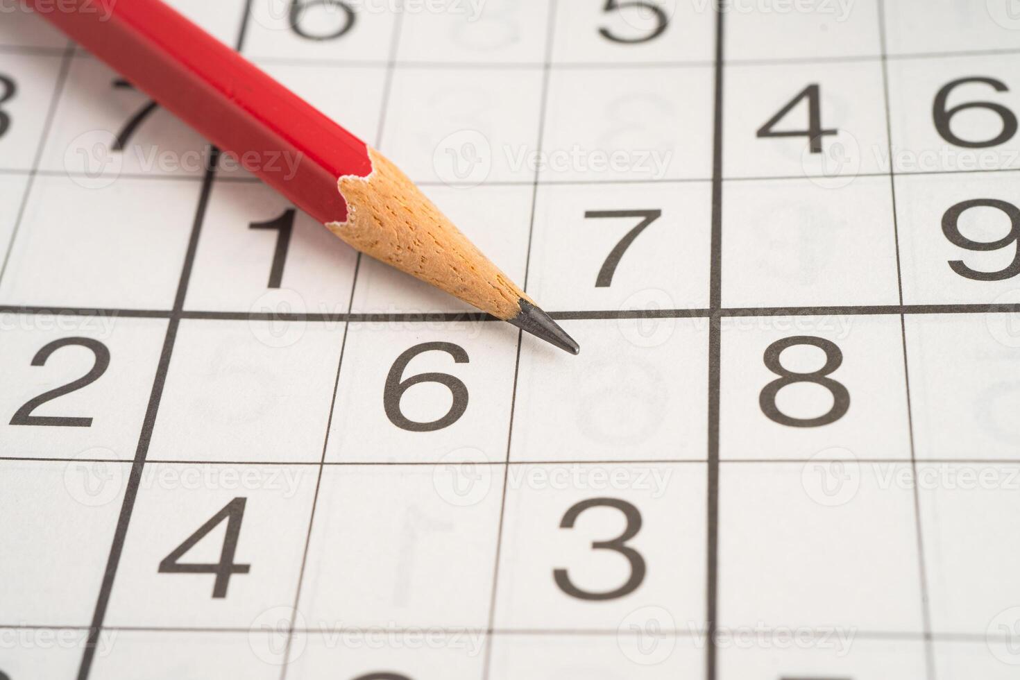 Sudoku puzzle game playing to challenge brain. photo