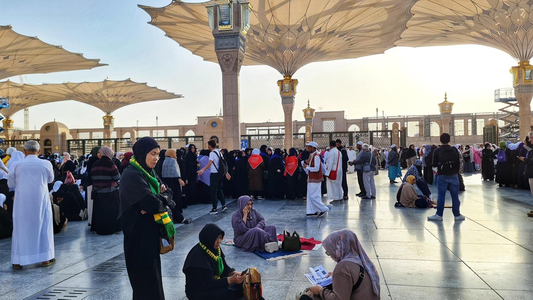 Medina, Saudi Arabia on March 1, 2024. Queues of female Umrah pilgrims from all over the world line up to enter Raudhah or the Tomb of the Prophet Muhammad. Gate 37. Use a registered Tasreh or Nusuk. photo