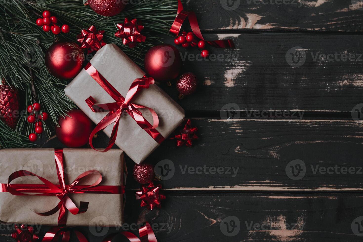 Top view photo Christmass flatlay gift boxes,red christmas tree toys and spruce brance on wooden background. Xmas backdrop with space for text.Copyspace.