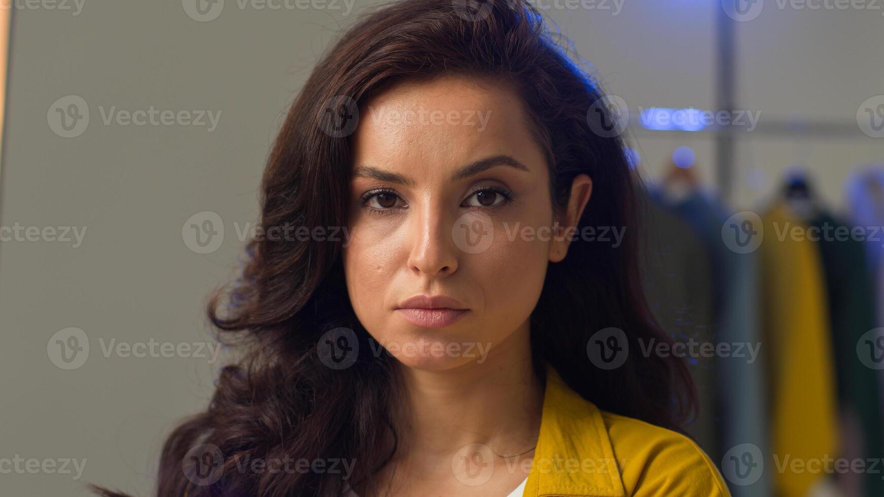 Carefree Caucasian woman happy girl model posing face looking at camera in studio strict gaze brunette female smile moving shoulders dance playful lady fooling around positive facial expression beauty photo