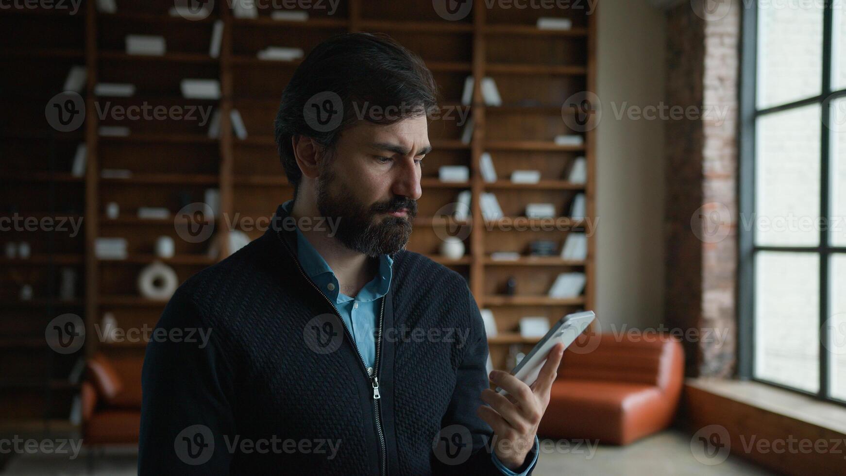 Dissatisfied middle aged Caucasian mature business man male businessman customer client speaking mobile phone call talk cellphone conversation irritated by bad connection low battery indoor apartment photo