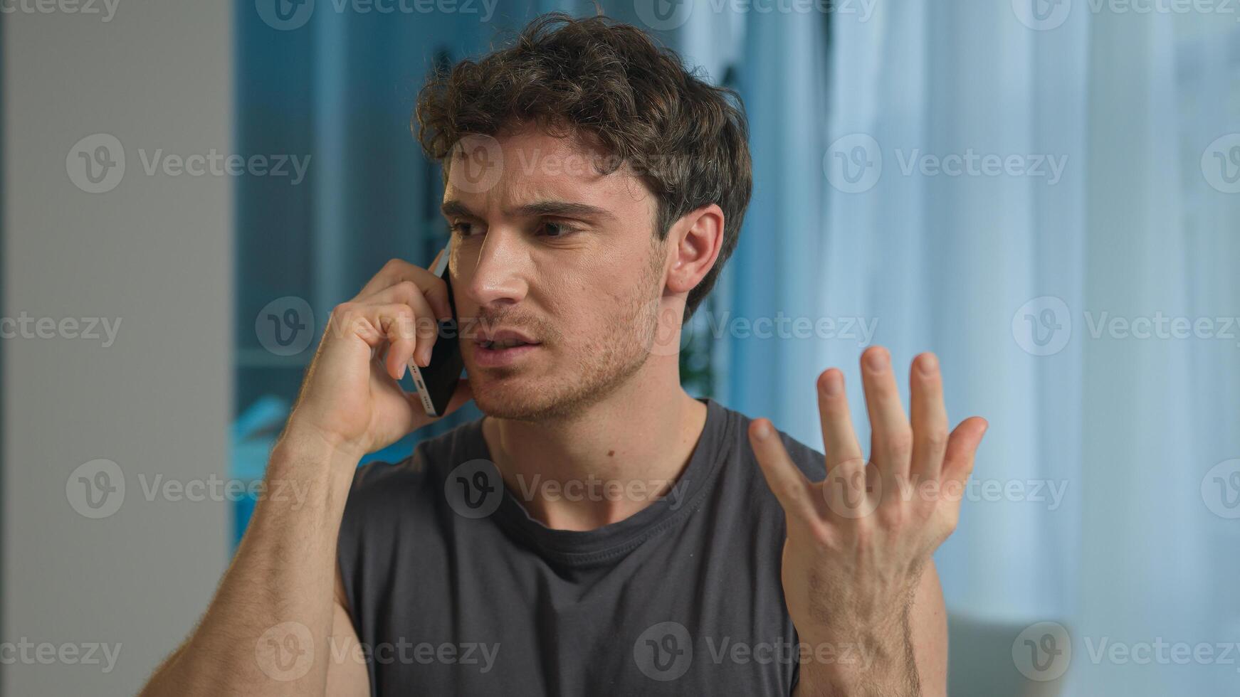 Caucasian man athlete talking mobile phone smartphone call sport guy male sportsman technology telephone anger annoyed frowning unhappy dissatisfied displeased home training problem communicate gadget photo