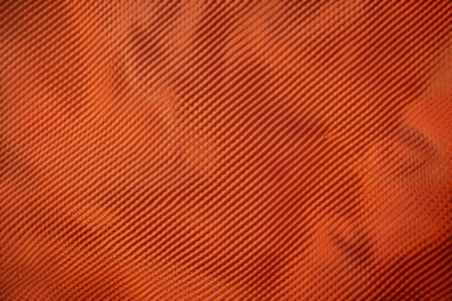 An orange-red ripstop texture with a subtle grid pattern photo