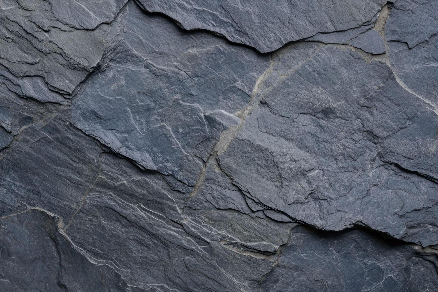 A rugged slate texture with natural grooves and subtle variations in tone photo