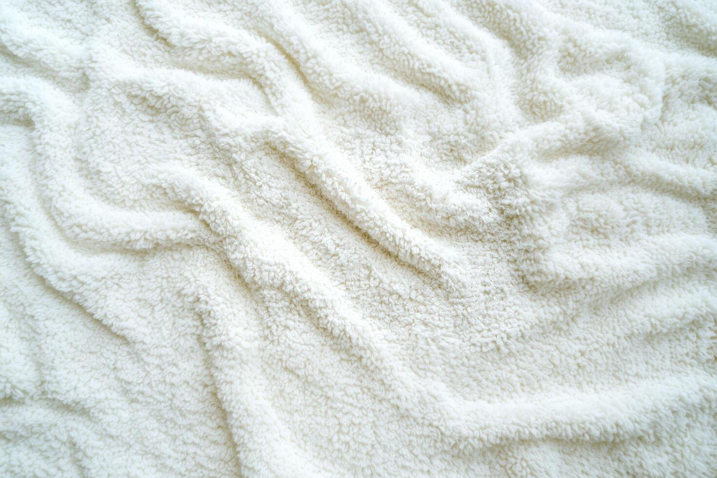 A soft, absorbent white terrycloth texture with looped cotton fibers, commonly used in towels and bathrobes photo