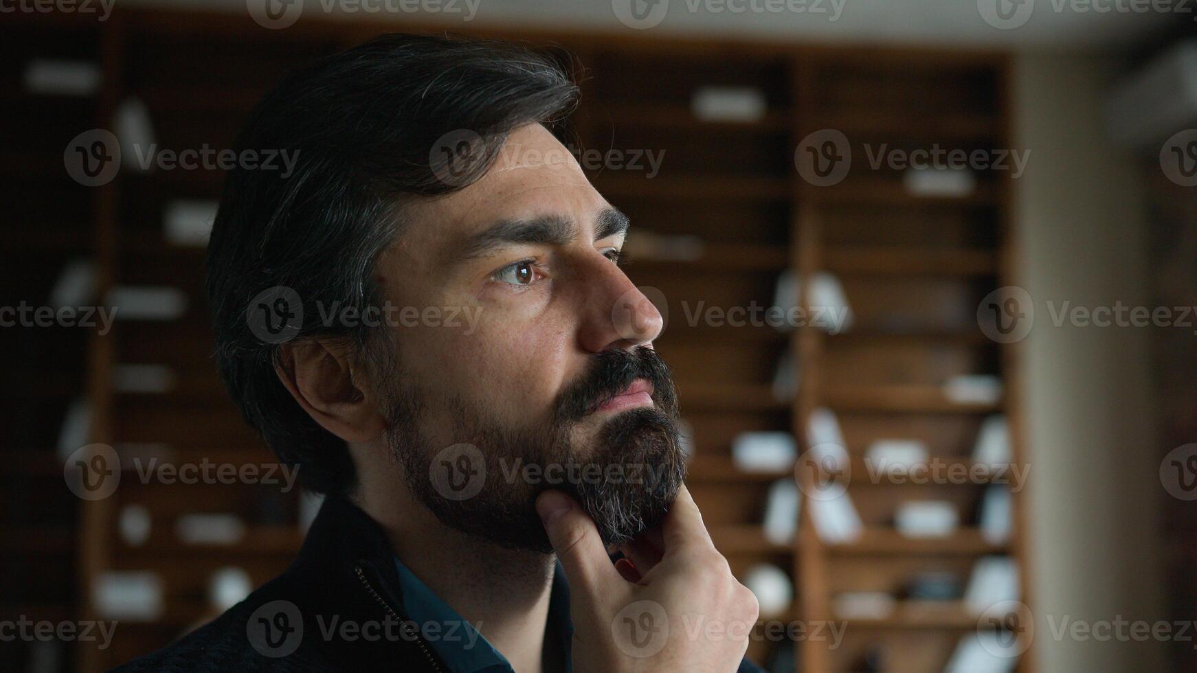 Thoughtful businessman psychotherapist portrait specialist Caucasian psychologist guy mature man male touching beard chin face friendly looking camera indoor business psychology clinic office cabinet photo