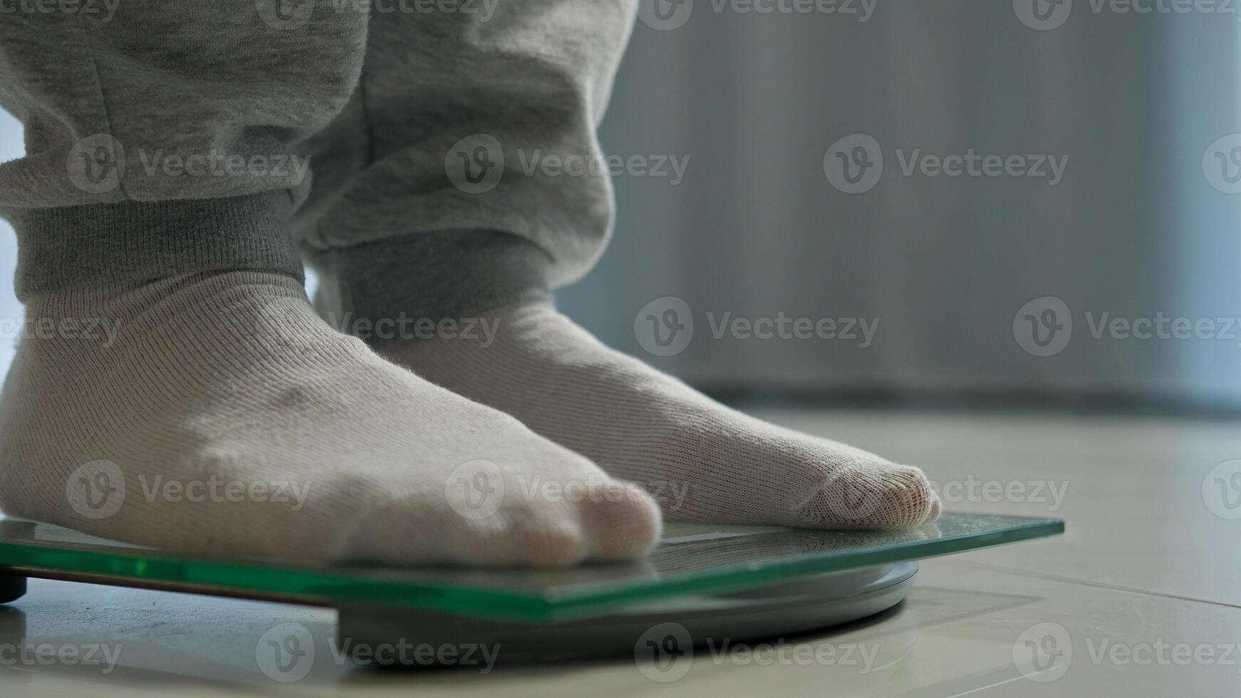 Man feet scales measuring losing weight male legs weighing stepping dieting health body mass digital device control counting wellness sport sportsman balance slimming flooring overweight obesity check photo