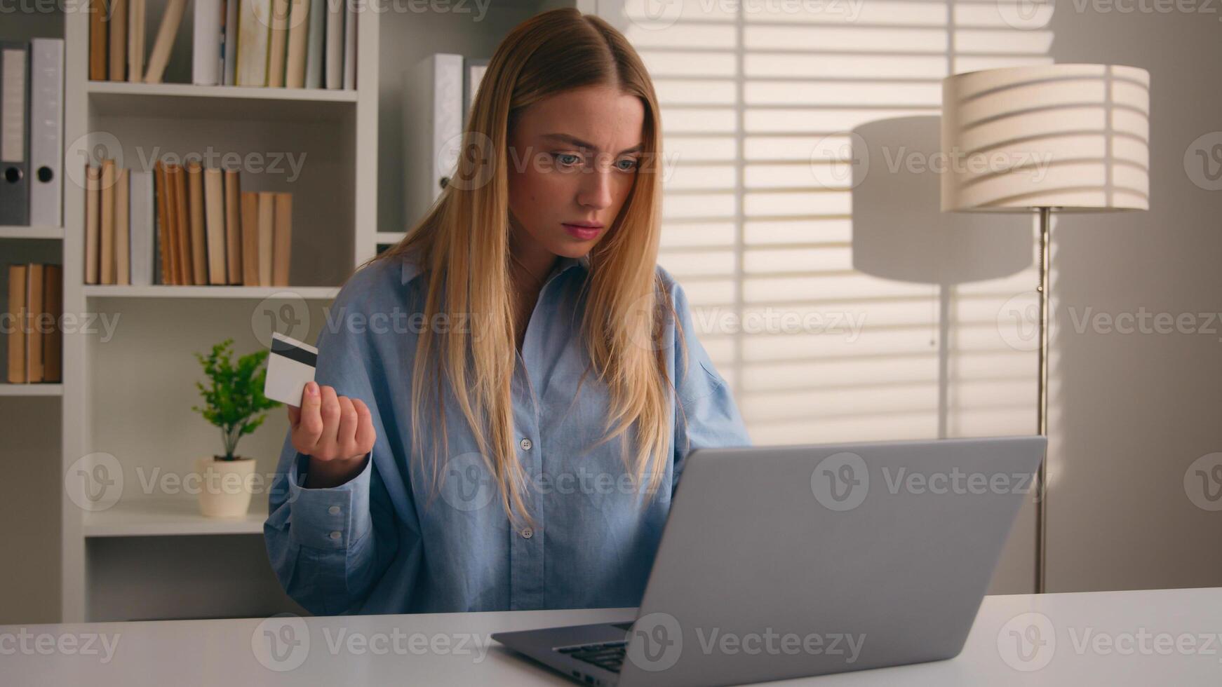 Confused puzzled client female hold bank credit card try to pay online annoyed with payment rejection problem wrong password. Worried girl woman trouble virtual money unsuccessful shopping with laptop photo