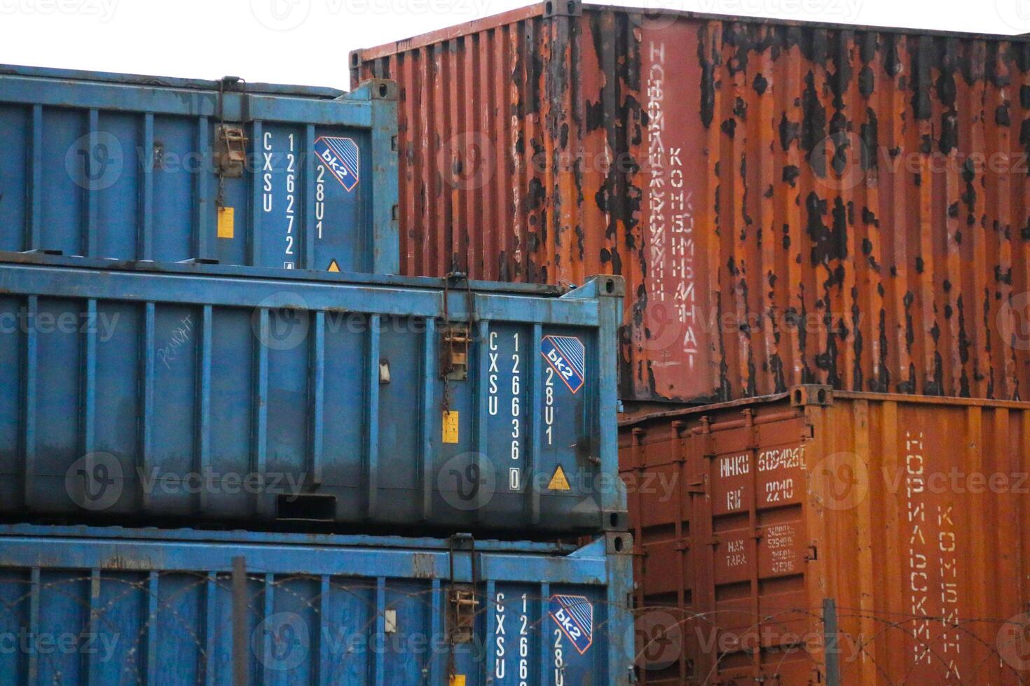 Stacked Cargo Containers Industrial Shipping Yard concepts Logistics, Global trade, Transportation. Mix Rusted newer container, showcasing diverse conditions robust nature International Commerce photo