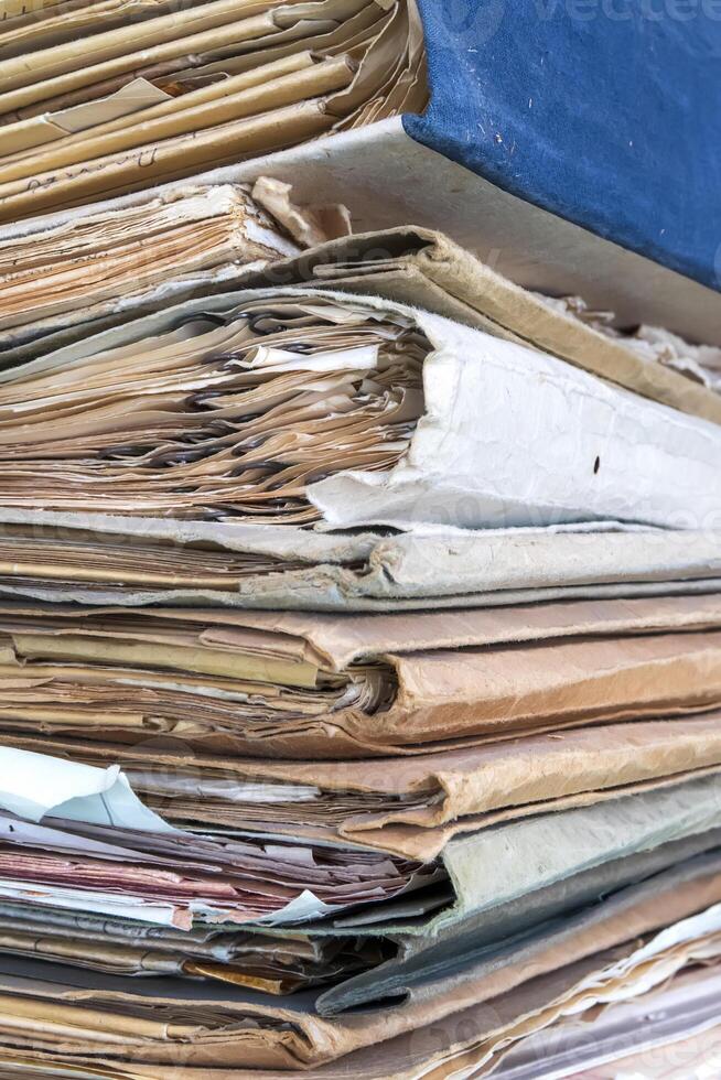 Old folders with documents in the library. Vertical view photo