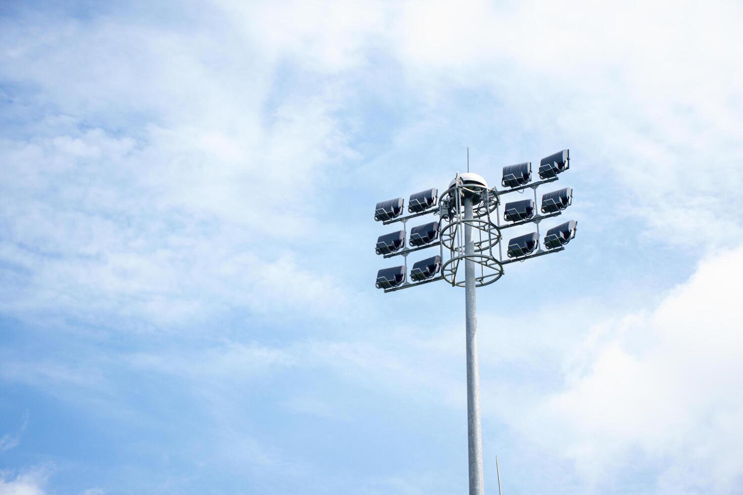 Bright Stadium Lights Against Blue Sky Background photo