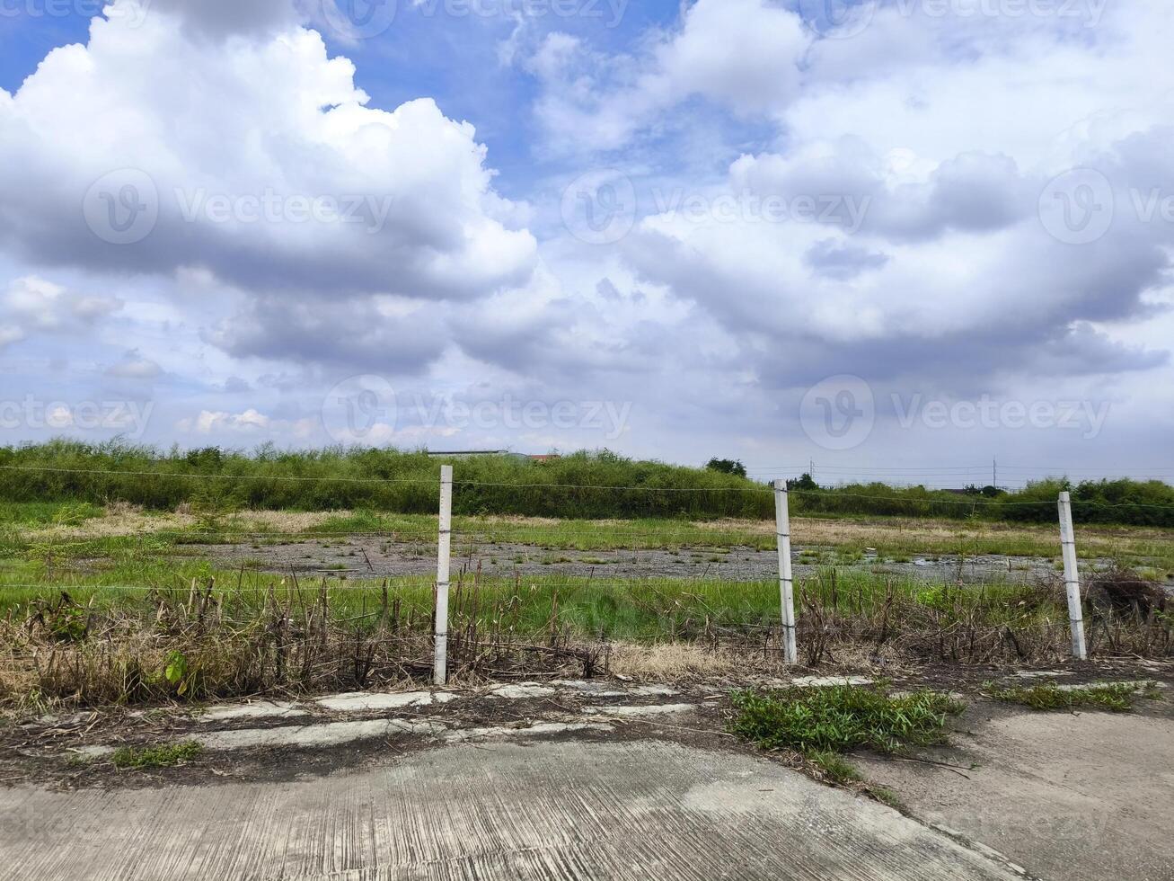 Land for sales concept. Landscape of empty land plot for development, and beautiful blue sky. photo