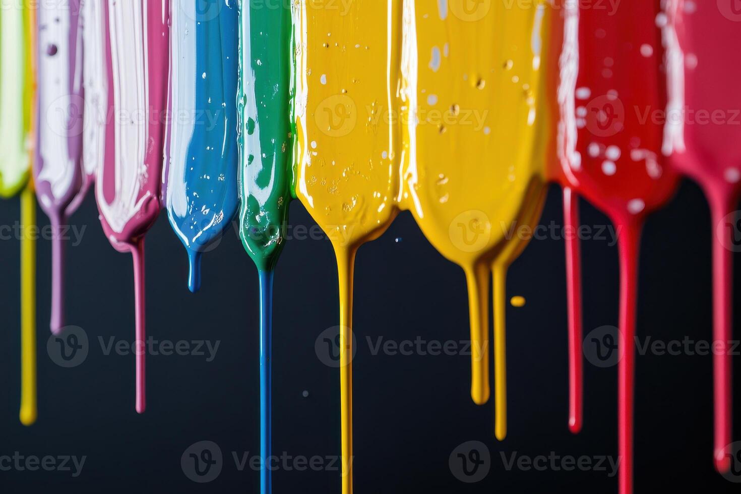 Colorful paints dripping from artist palette in vibrant display against a dark background photo