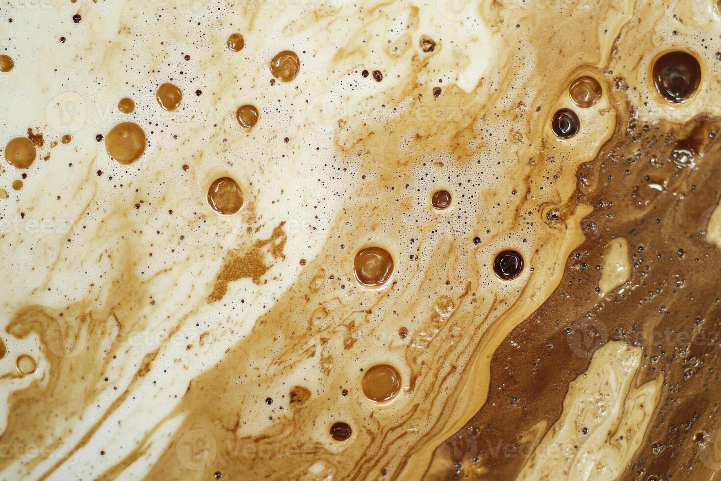 Swirling patterns of brown liquid with bubbles captured in a close-up view in natural light photo