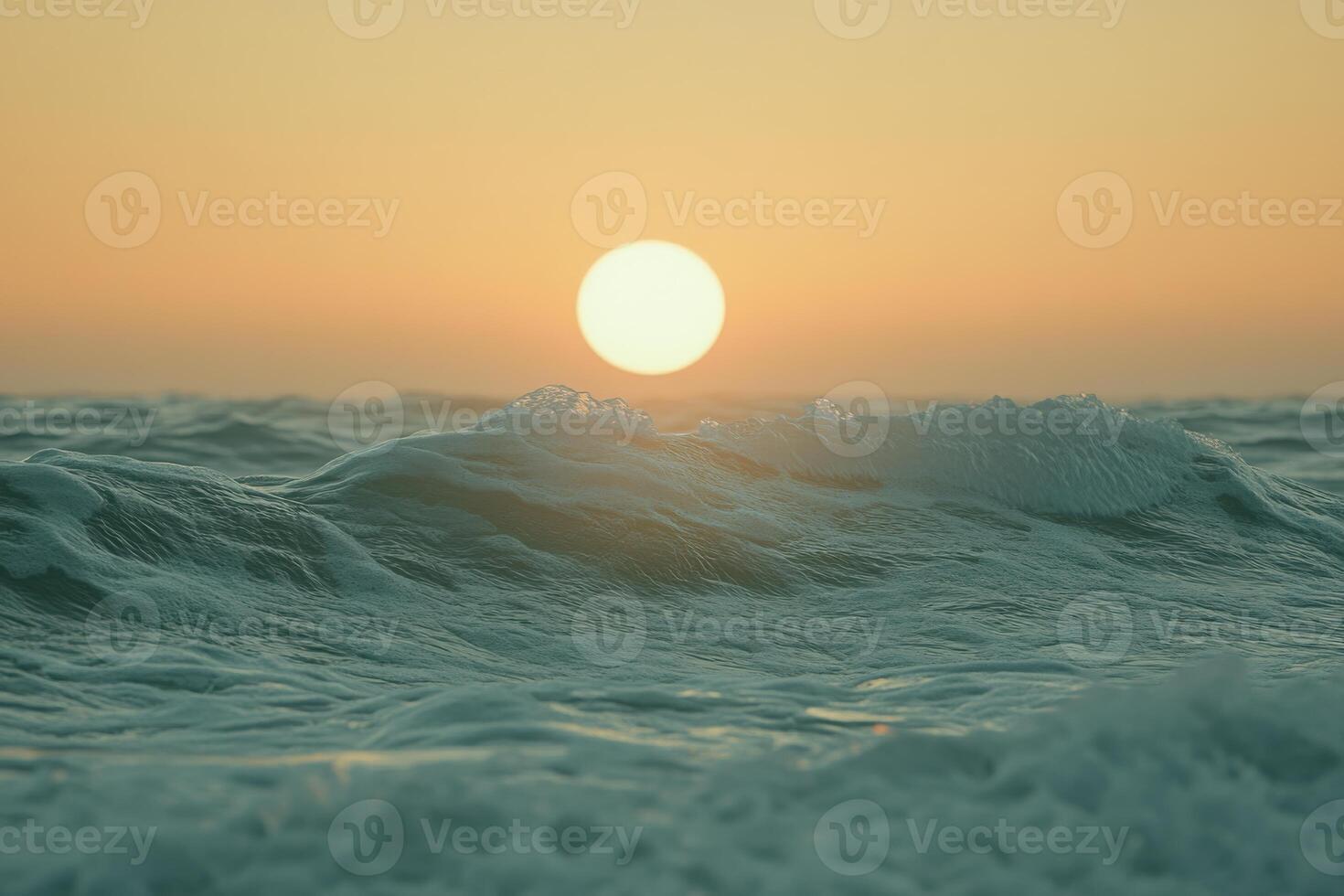 Golden sun setting over waves in a serene ocean, creating a tranquil atmosphere at dusk photo