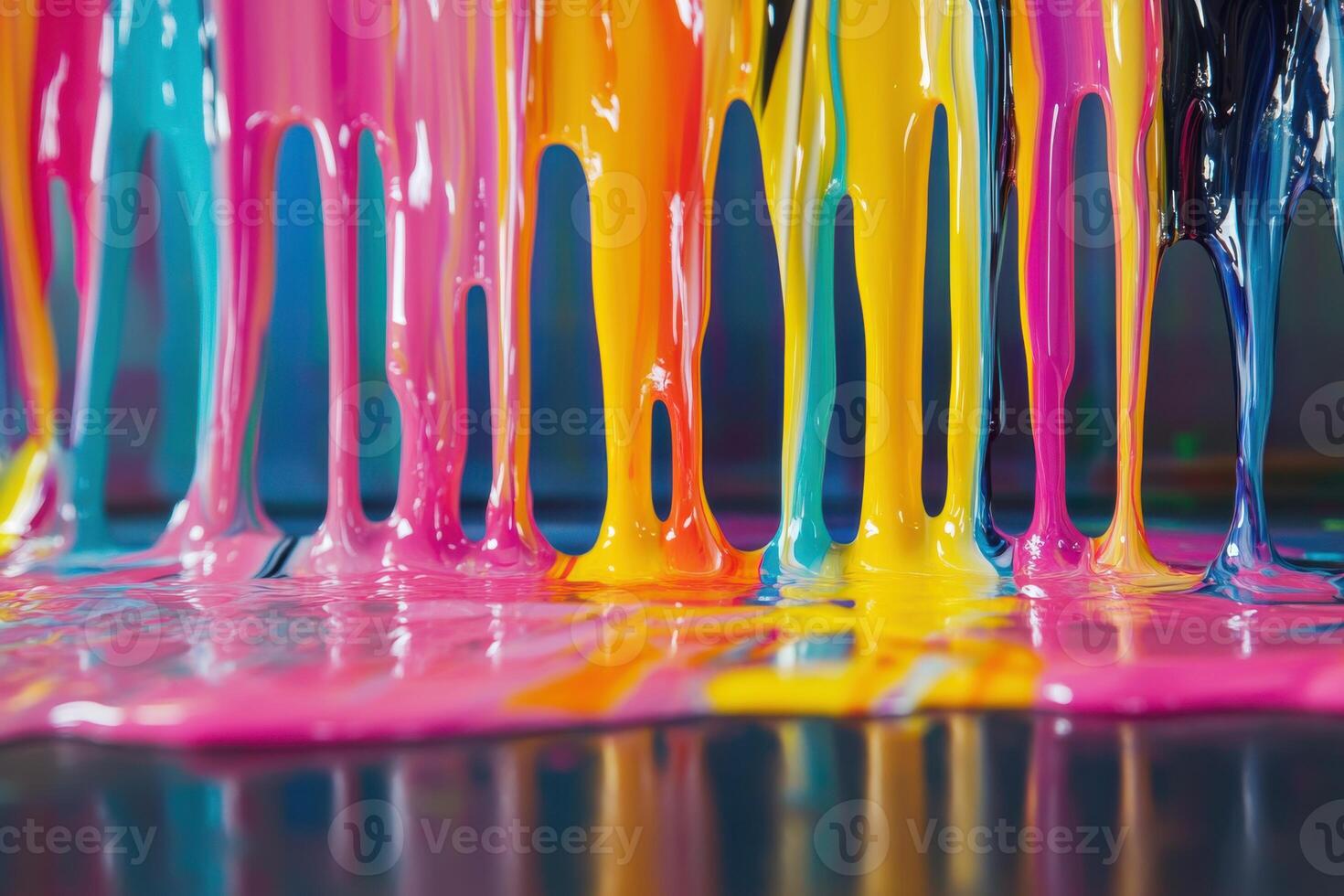 Vibrant paint colors dripping and mixing on a flat surface during an art session in a studio photo