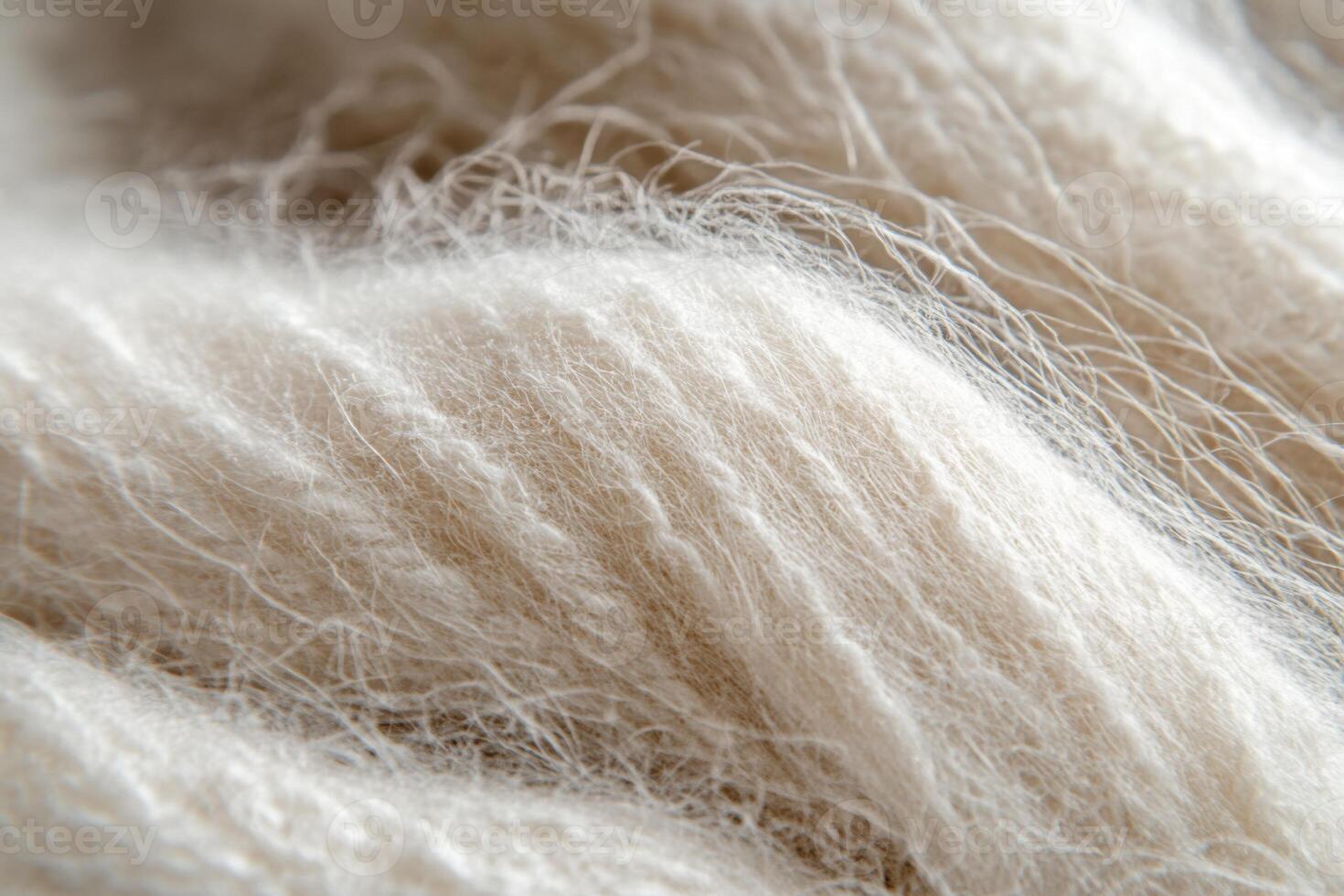 Soft cream-colored wool fibers intertwined in a cozy texture ideal for knitting and crafting photo