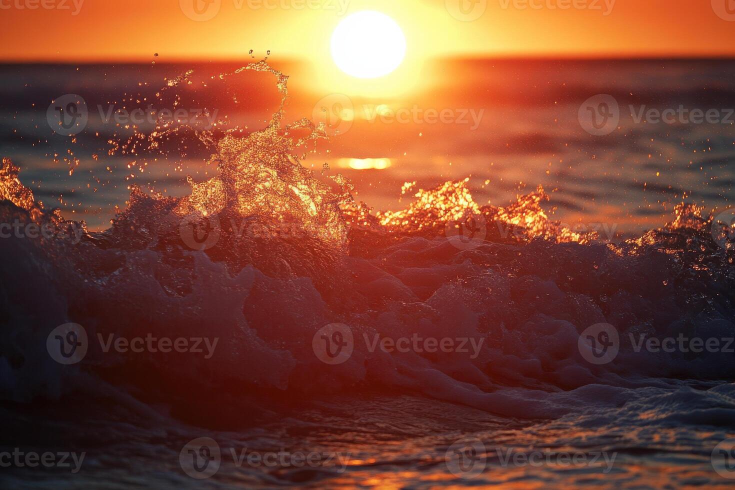 Sunset over the ocean with splashing waves at the shoreline in the evening glow photo