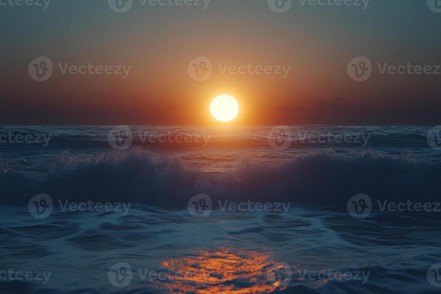Spectacular sunset over the ocean waves, casting a warm glow on the water at twilight photo