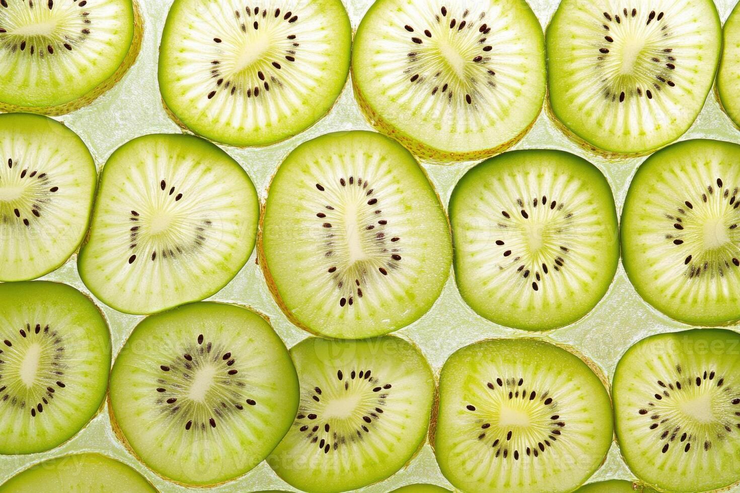Sliced kiwifruit arranged neatly on a light surface for a fresh and vibrant display during midday photo