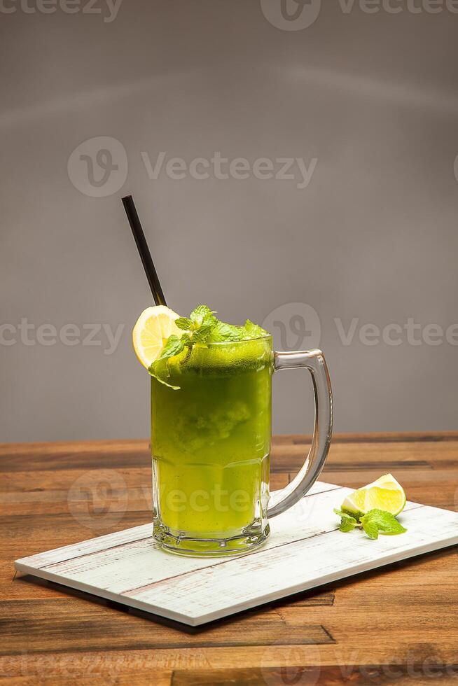 Refreshing Mint Lemonade, Lemon with Mint served in mug isolated on wooden table side view of cold beverages drink photo