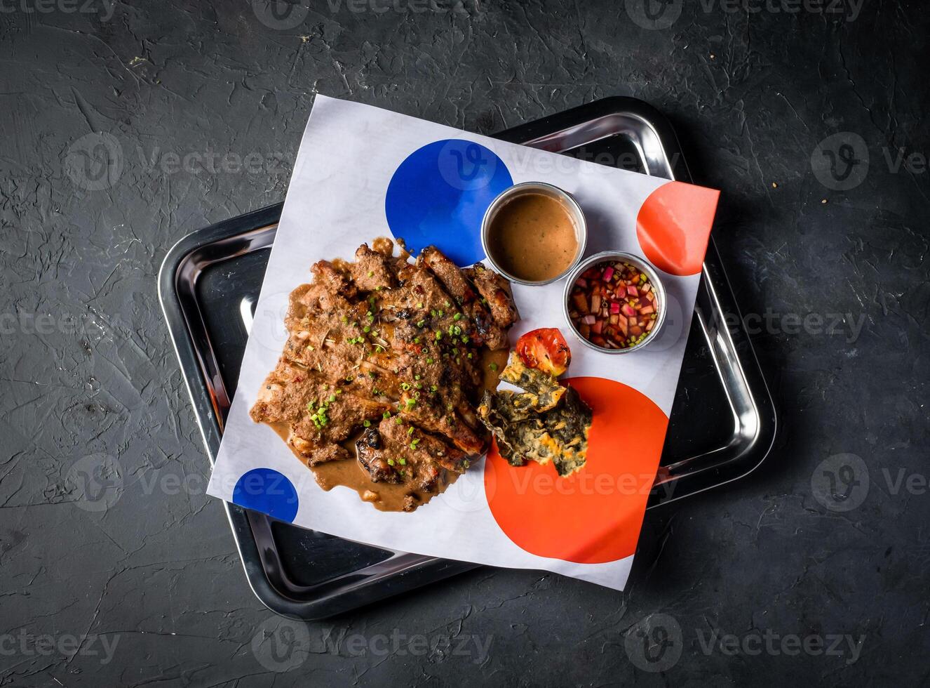 Spicy Grilled Jerk Chicken Slice with Sweet and Sour Sauce served in tray isolated on grey background top view of A la carte Food platter photo