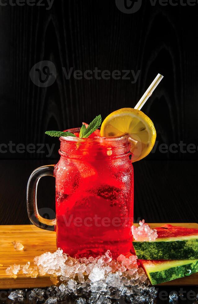 WATERMELON MOJITO Lemonade with Mint and Lime served in jar with straw isolated on wooden board side view of perfect drink for a hot summer day photo
