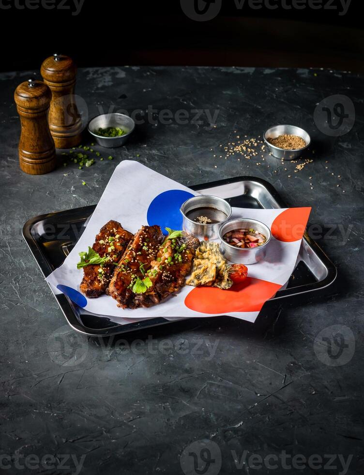 Hickory Bbq Beef Brisket Belly with Dipping Sauces and green onion served in tray isolated on grey background side view of A la carte Food platter photo