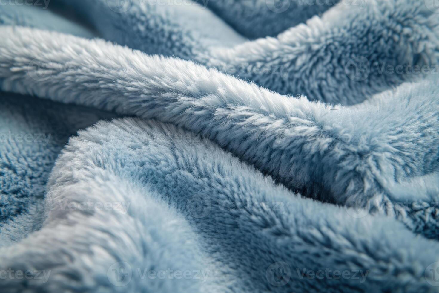 Soft blue plush fabric drapes over a surface, showcasing its texture and color in natural light photo